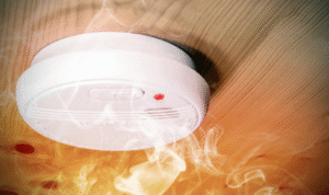 How can checking smoke alarms or gas leak detectors on a fixed date each month improve safety?