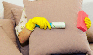 How can keeping a lint roller handy help you quickly freshen up upholstery before guests arrive
