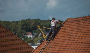 How can noticing loose gravel, tiles or debris on the roof warn you about wind damage or neglect