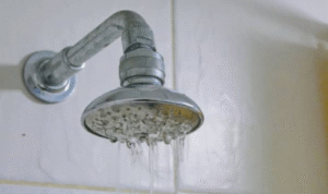  How can watching for white, chalky deposits on taps and showerheads tell you about hard water issues?